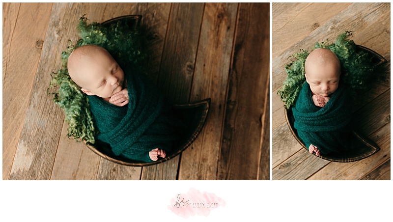 Baby boy wrapped in green in moon prop